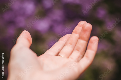 a woman's hand on a lilac background © alenagurenchuk