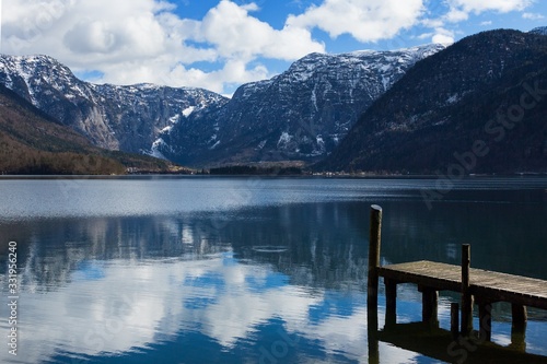 View idyllic Alpine mountains and lake. Focus on wooden pier. Sunny winter morning in Hallstatt  Austria  Europe