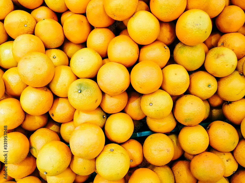 Organic and fresh oranges on fruit market. Boxes full of ripe oranges for sale on farmers market. Fresh fruit display in shop. Juicy oranges at the greengrocer's stall. Organic and fresh oranges on fruit market. Boxes full of ripe oranges for sale on farmers market. Fresh fruit display in shop. Juicy oranges at the greengrocer's stall.