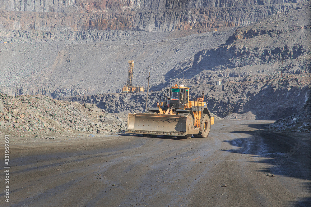 Wheel dozer rides on the road in a quarry Wheel dozer rides on the road in a quarry