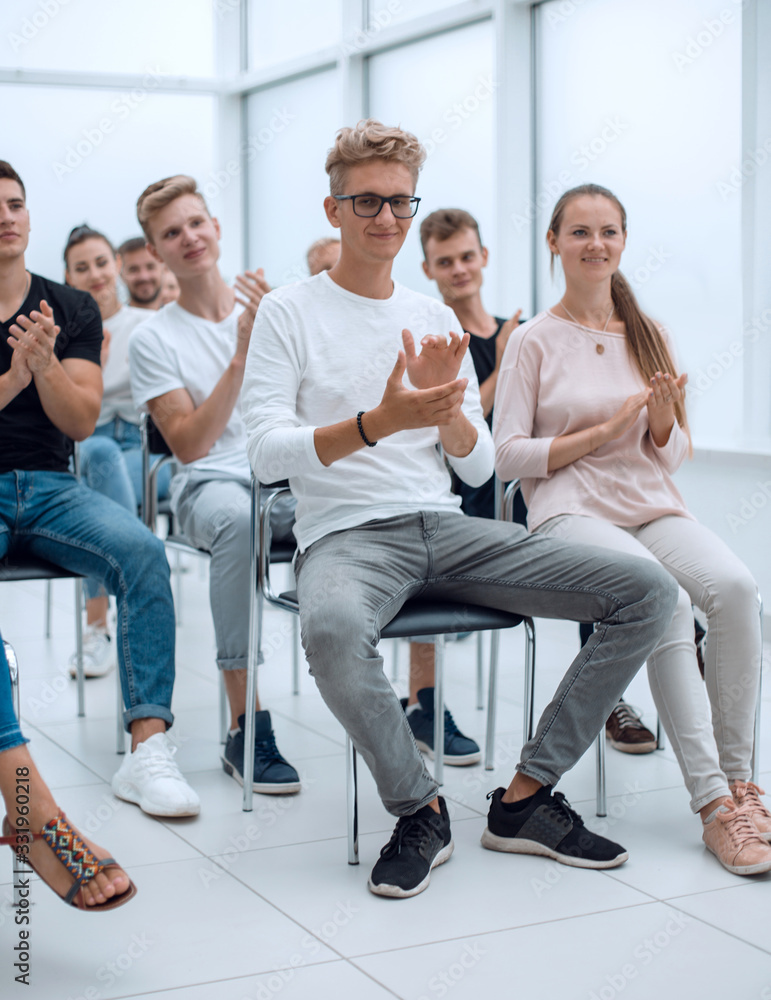 Fototapeta premium group of young people applaud at a group meeting