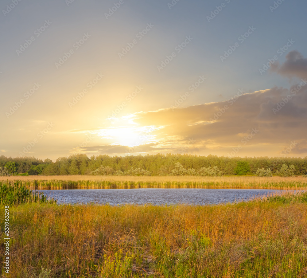 small lake among a prairies at the sunset, outdoor evening scene