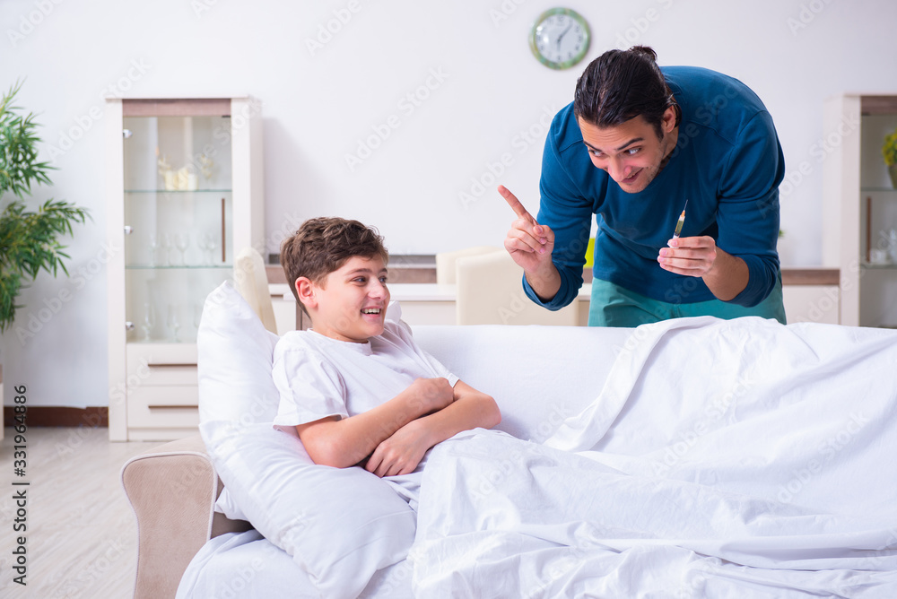 Fototapeta premium Young father caring for sick son