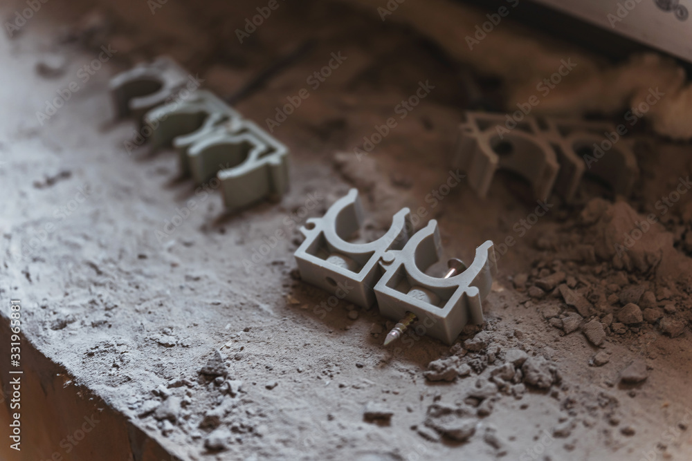 Plastic electric cable holders with nail. Holders for electrical wiring