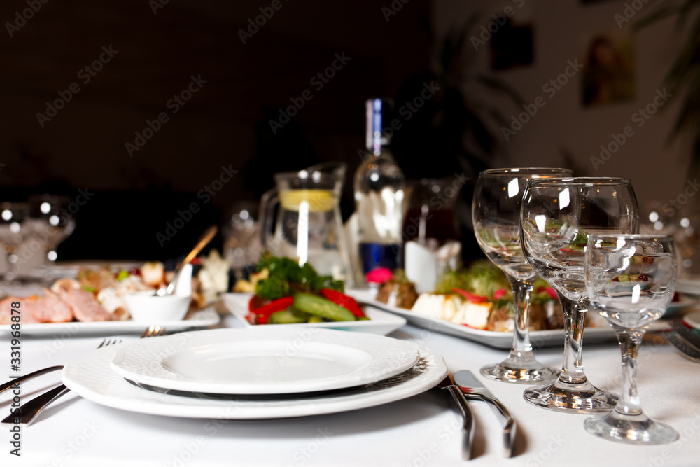 Restaurant tables set for celebration.  Many food on the festive table