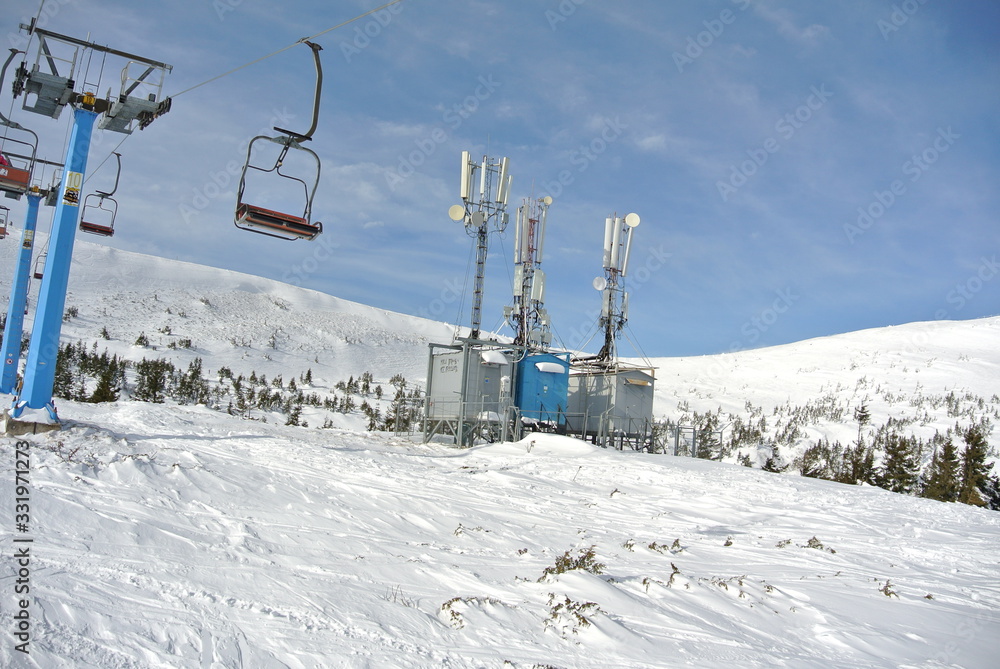 Chair lift the Karpaty mountains with the forest on the background Chair lift the Karpaty mountains with the forest on the background