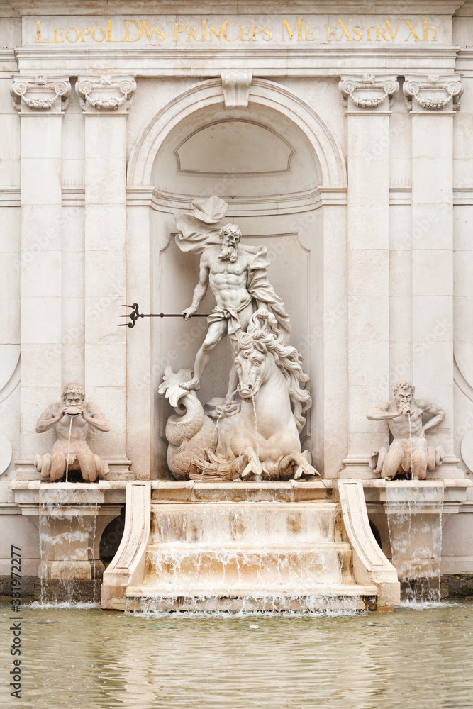 Marble Neptune statue of the fountain at Kapitalschwemme (Horse Pond) on Kapitelplatz, town square in Salzburg, Austria