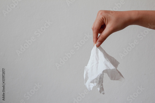 Beautiful hand holding tissue paper on white background. drity tissue.  photo