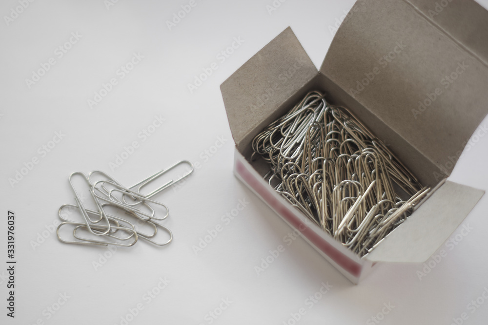 Fototapeta premium Paper clips close up in box isolated on white background
