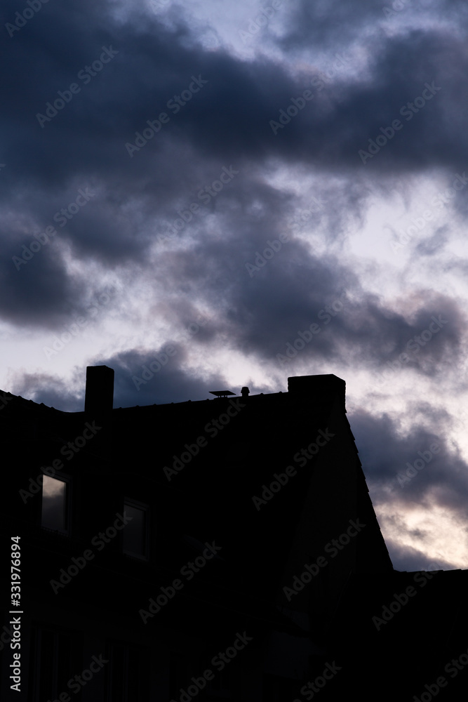 Silhouette of building and dramatic cloudy sky