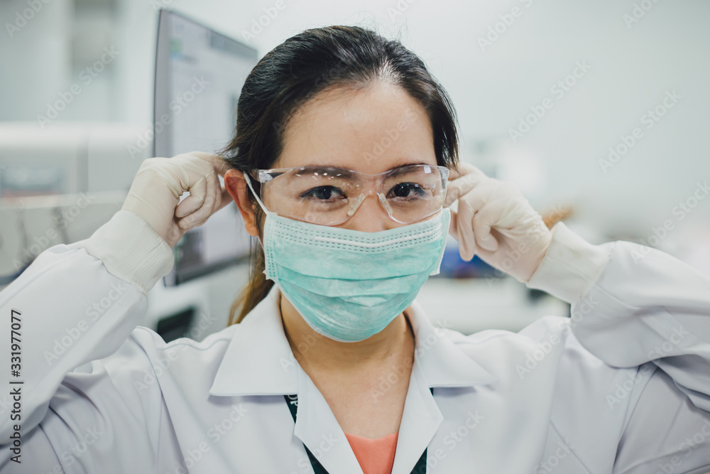 Doctor or scientist wearing surgical mask for prevention of coronavirus or covid-19 which is airborne infection disease to stop virus outbreak. Medical and microbiologist science concepth photo. Doctor or scientist wearing surgical mask for prevention of coronavirus or covid-19 which is airborne infection disease to stop virus outbreak. Medical and microbiologist science concepth photo.