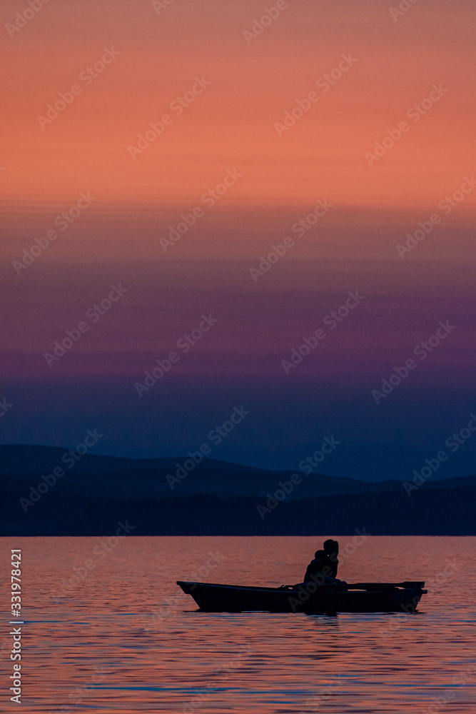 Silhouette of a boat on the water during sunset