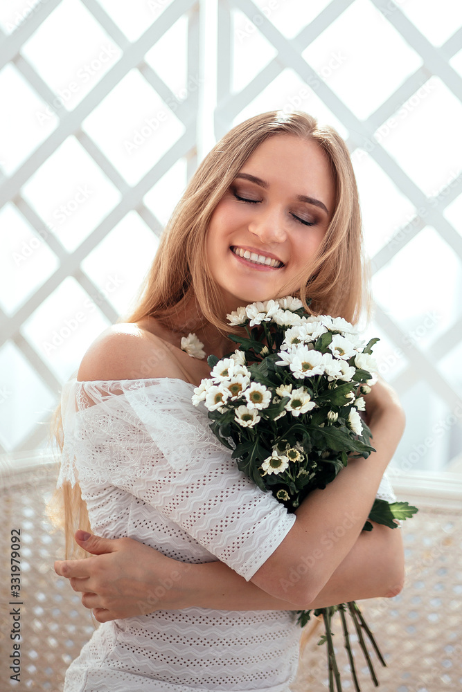 the girl enjoys her morning coffee and enjoys a bouquet of flowers