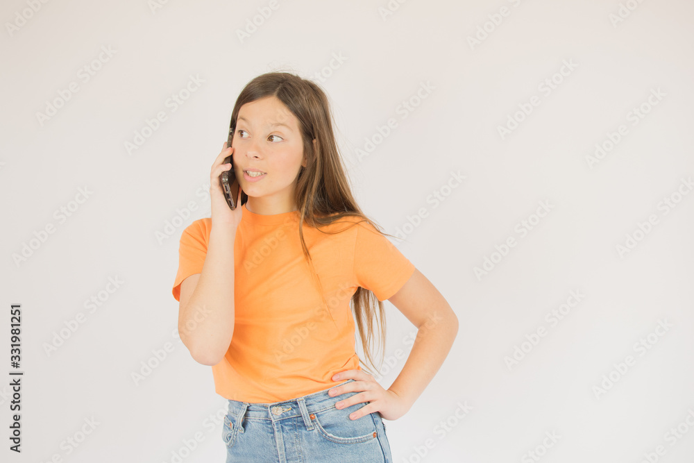 Girl in orange talking on the phone Girl in orange talking on the phone