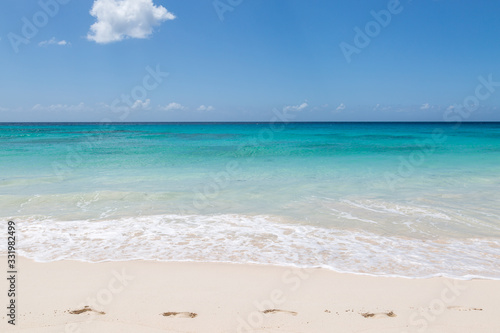 Footprints on an idyllic sandy beach, on the Caribbean island of Barbados