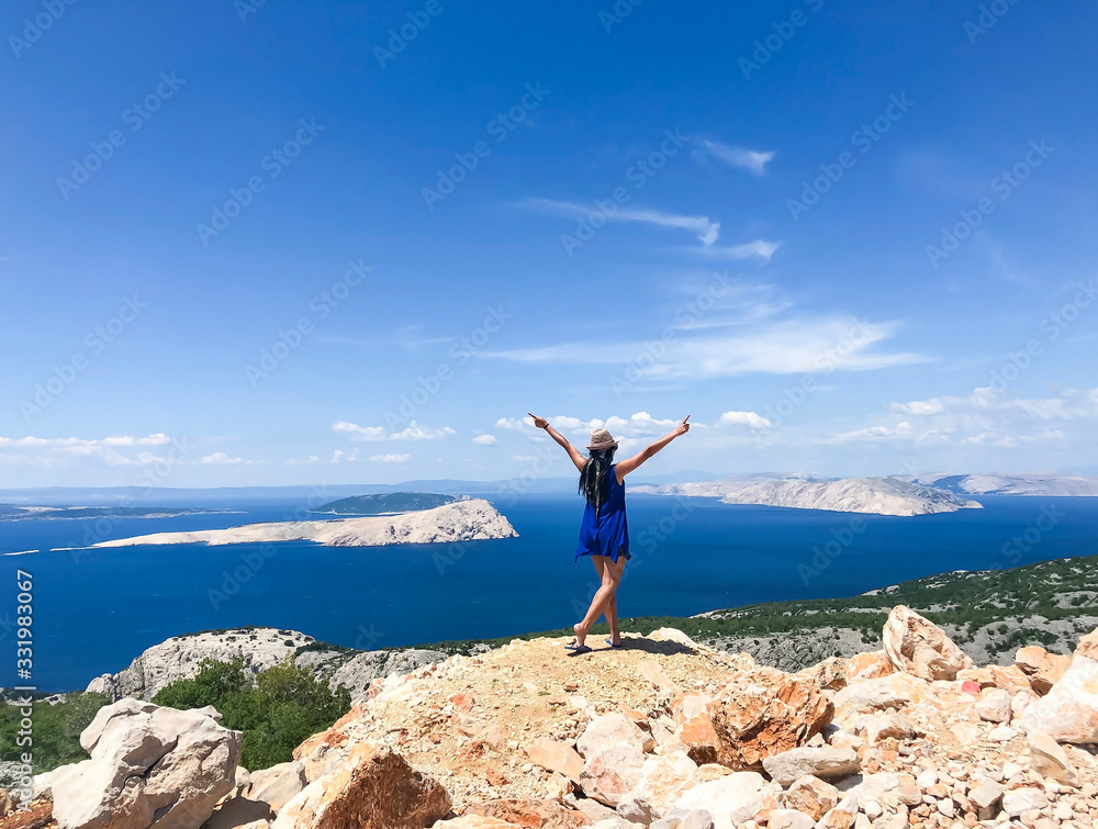 Female traveler from behind enjoying view of islands and Adriatic sea of Croatia in summertime on road trip Female traveler from behind enjoying view of islands and Adriatic sea of Croatia in summertime on road trip