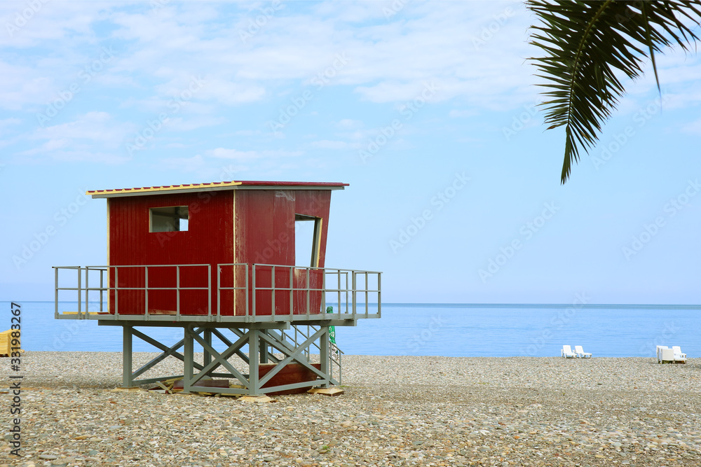 Red lifeguard hut on the empty beach