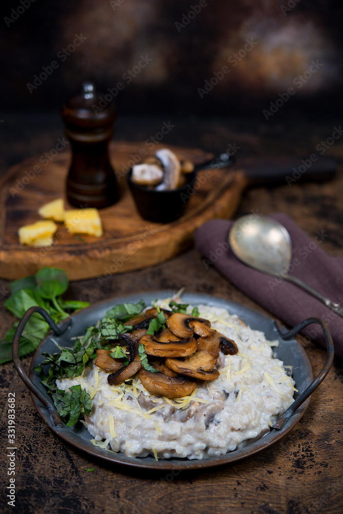 Italian dish risotto with mushrooms, Parmesan and herbs.
