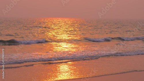 sunshine from sunset at beach  scenery  on wet sand and incoming ocean waves