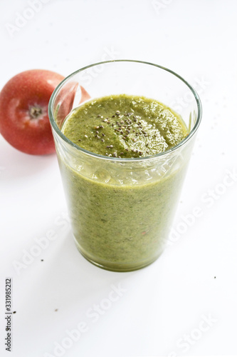 Mixed green smoothie with apples on a white background