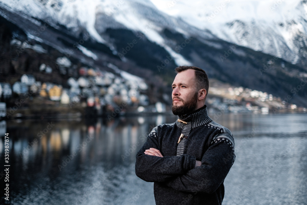Man in front of beautiful town of Odda, Norway