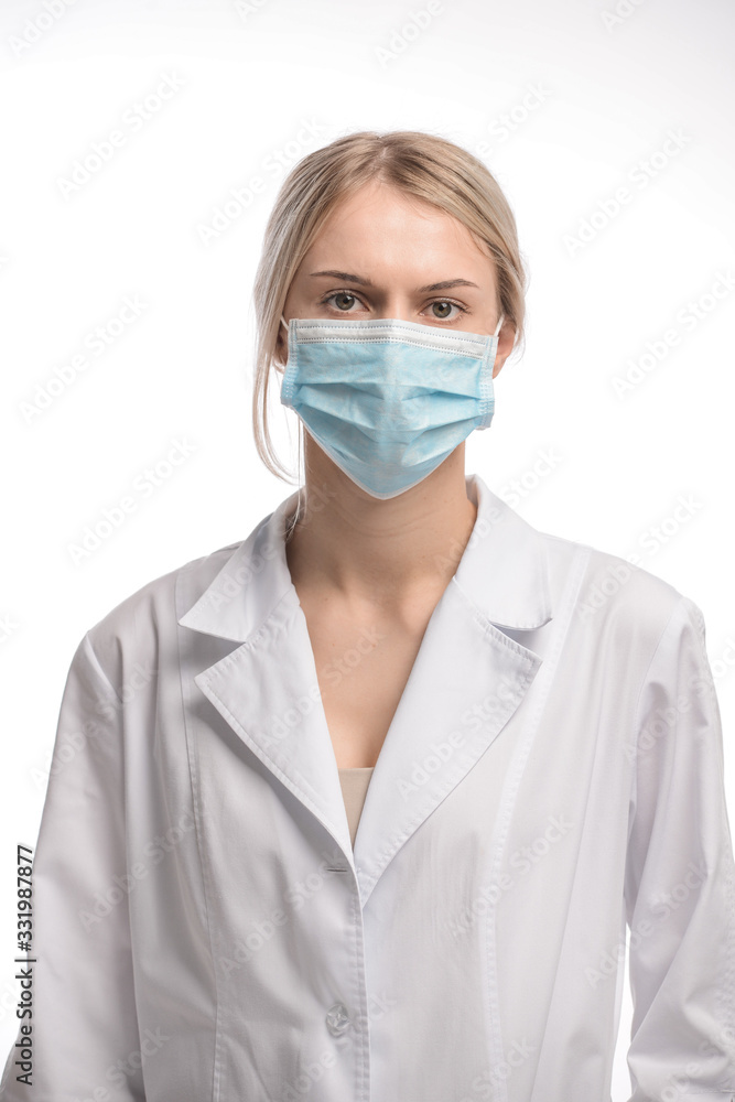 young beautiful girl with blond hair in a medical mask. On white background. Coronavirus young beautiful girl with blond hair in a medical mask. On white background. Coronavirus