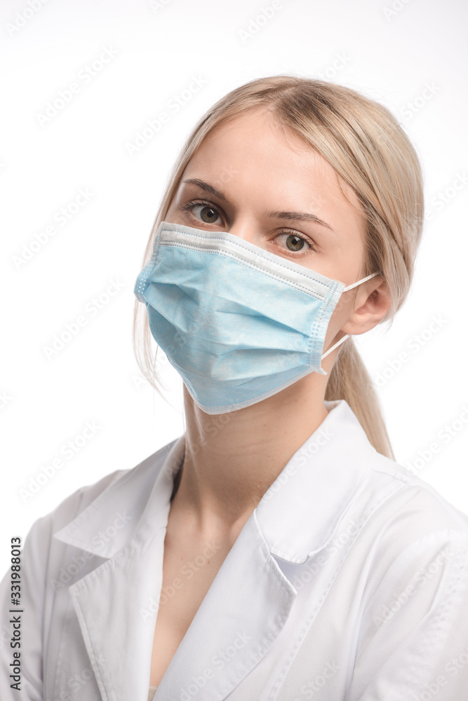 young beautiful girl with blond hair in a medical mask. On white background. Coronavirus young beautiful girl with blond hair in a medical mask. On white background. Coronavirus