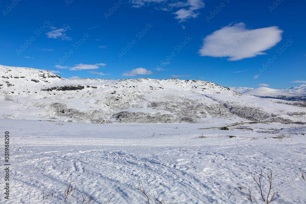 Winter and sun with great ski conditions on the Tosen mountain in Grane municipality, Northern Norway