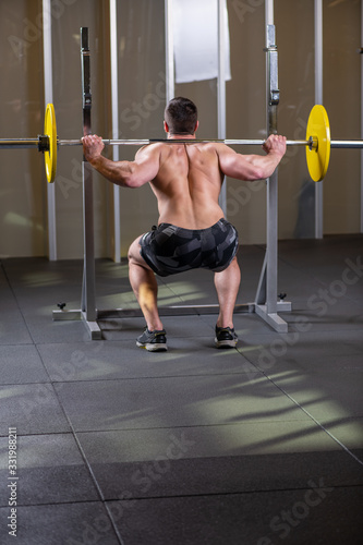 Sexy muscular man doing squat exercise. Back view © cirkoglu