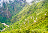 Steep serpentine road in green jungle leading to Machu Picchu