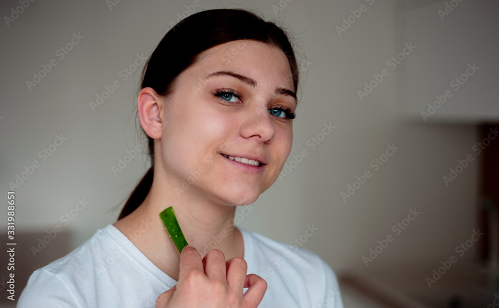 Young woman uses aloe vera on her neck Young woman uses aloe vera on her neck