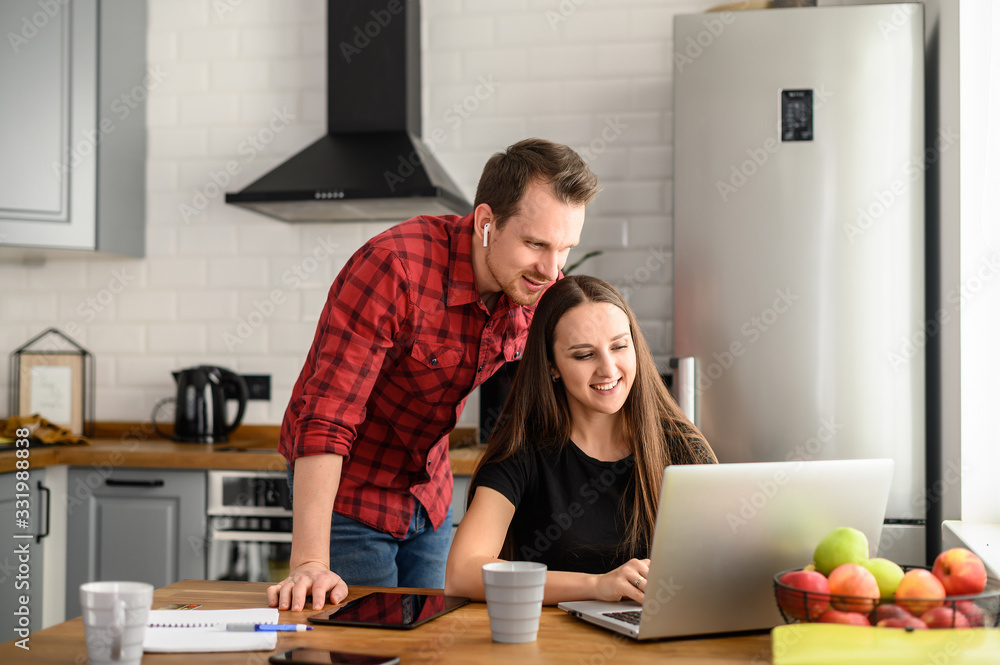 Young family do online shopping in a new home Young family do online shopping in a new home