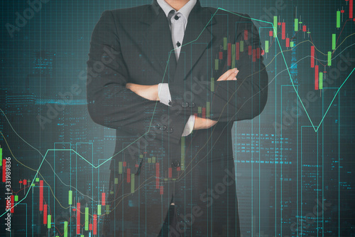Double exposure businessman on city and trading investment graph and trend  background
