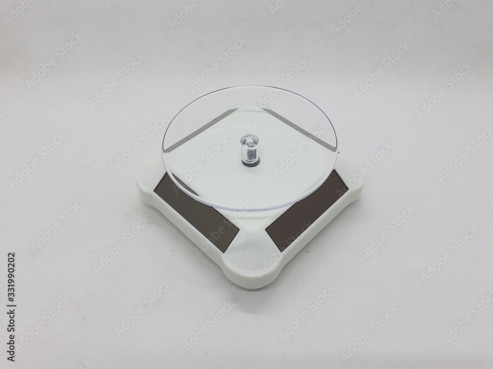 Clean Colorful Electronic Rotating Display with Solar Battery Power Panel for Exhibition Show Purpose in White Isolated Background Clean Colorful Electronic Rotating Display with Solar Battery Power Panel for Exhibition Show Purpose in White Isolated Background
