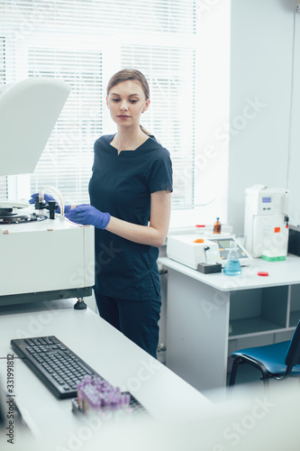 Young woman in modern medical laboratory stock photo