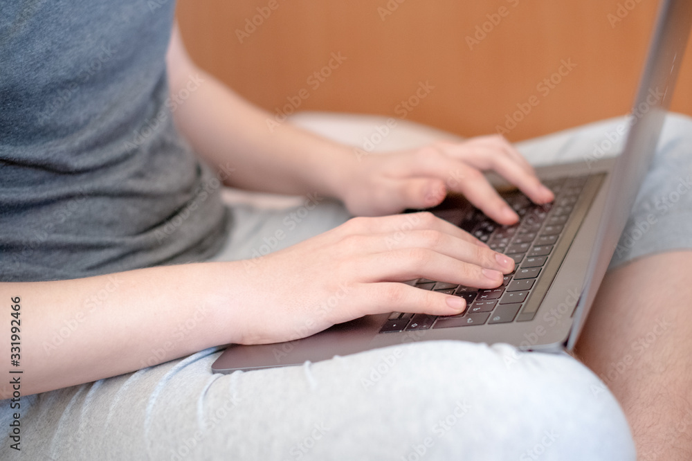 The student is quarantined and remotely studies at home and works on a laptop. The concept of quarantine and virus. The student is quarantined and remotely studies at home and works on a laptop. The concept of quarantine and virus.