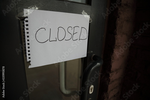 Handwritten note Closed on the building entrance door