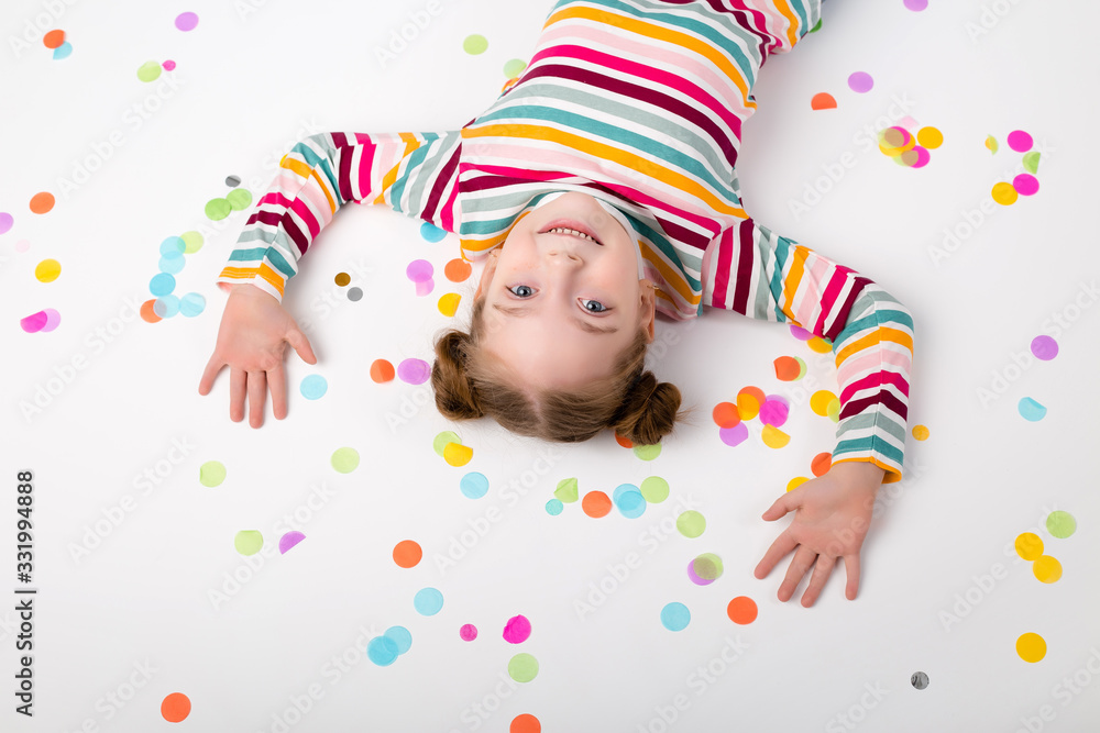 Fototapeta premium Happy baby girl with confetti on white background