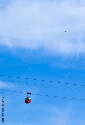 cable car on background of blue sky and clouds