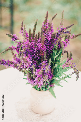 Beautiful bouquet of bright wildflowers with decorative elements