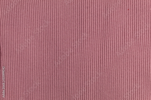 Background. Texture. Pink knitted fabric with pronounced stripes.