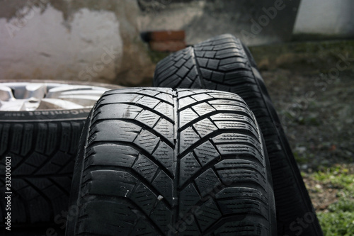 a lot of car black tires with different tyre tread stack together in a group. 