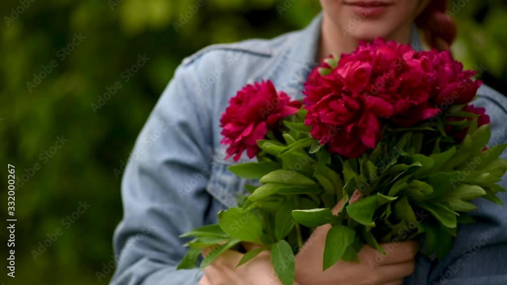 Attractive happy woman with pink hair holds peony Attractive happy woman with pink hair holds peony