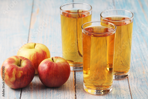 Glasses with apple juice and ripe apples	