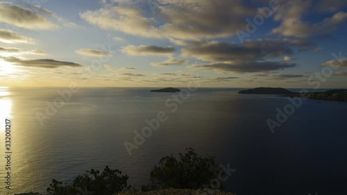 sunrise in the bay of Punta Grossa, ibiza, balearic islands, spain, mediterranean sea, cloudy sky.