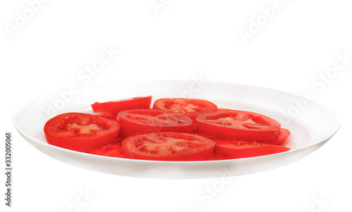 Tomatoes on a white plate cut into circles