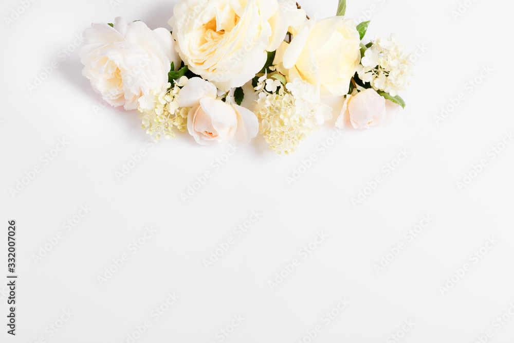 Fototapeta premium Festive flower composition on the white background. Overhead view