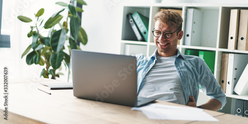 Smiling young man working at home