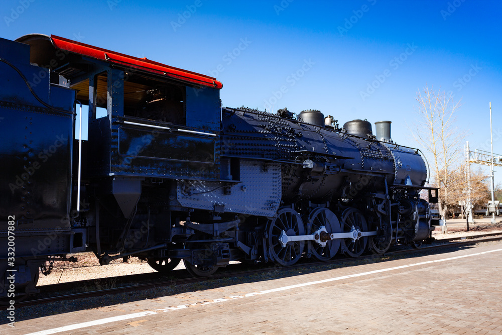 Close view of an old steam iron big locomotive on the station in Arizona, USA