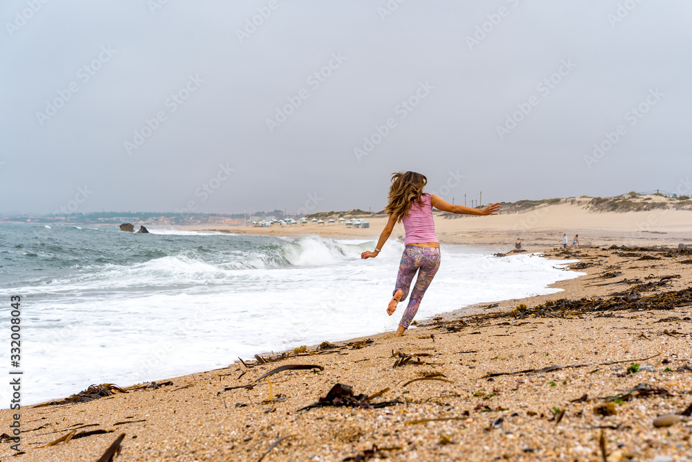 Young fitness woman running and having fun at the Miramar beach Porto